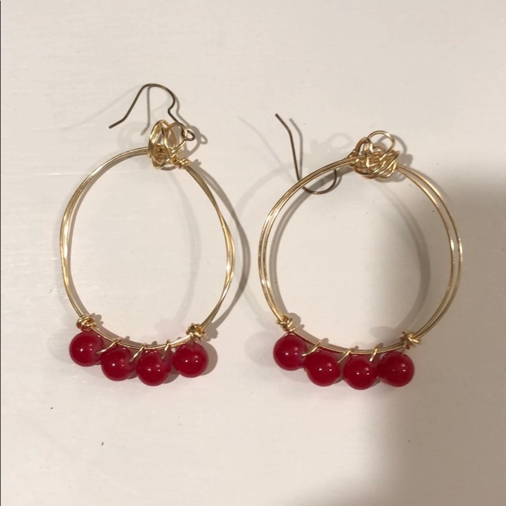 Gold hoop earrings with red beads